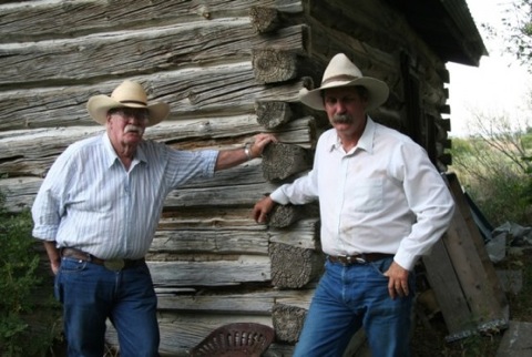 Wally-McRae-and-Clint-McRae-by-historic-cabin-on-their-ranch-e1378236096464-555x373